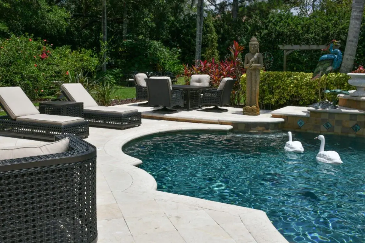Outdoor living styled with curated furniture and sculptures — Kynform extends interior design expertise beyond the home to create complete lifestyle environments.